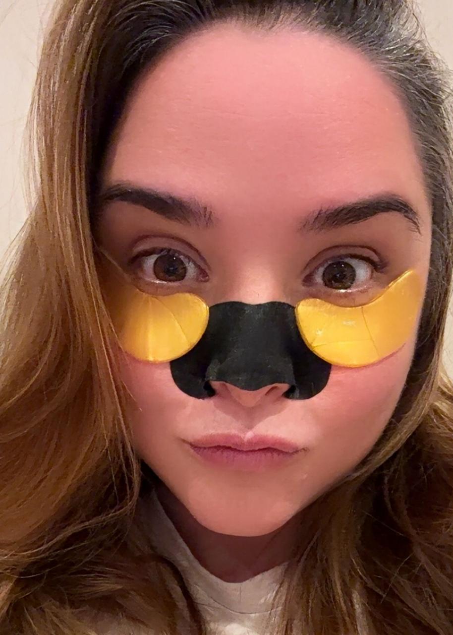 Lulu making a playful face with gold under-eye patches and a black nose patch.